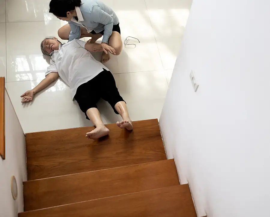 slip and fall accidents concept - Young Asian American woman rushes to her mother's aid after a slip and fall down the stairs - Jacksonville, IL