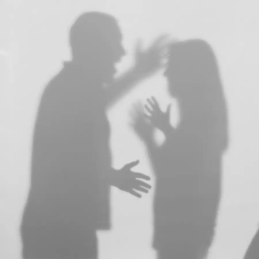 Domestic violence concept - shadows against the wall, angry husband raising his hand to strike his wife - Order of protection - criminal defense - Jacksonville, IL