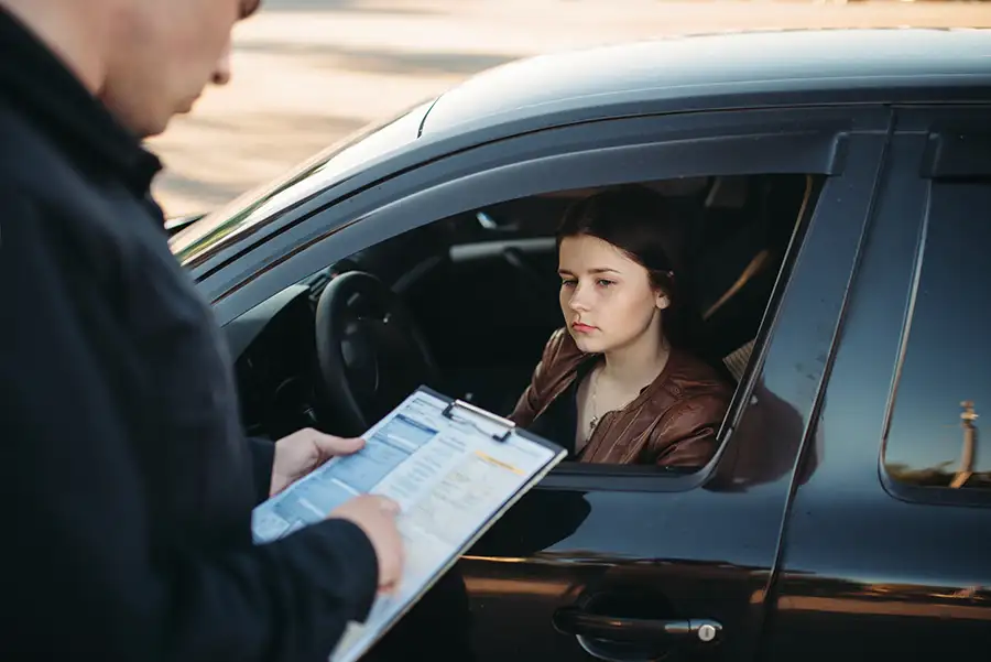 young female driver receiving a traffic ticket - Jacksonville, IL